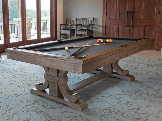 table with pool cues on it in a carmel color